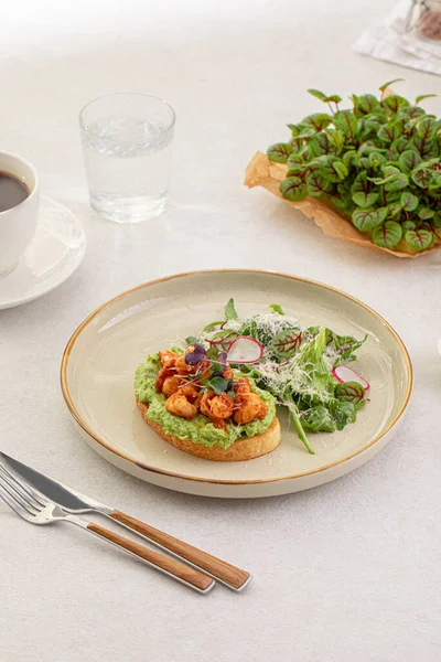 Stock image Portion of avocado toast with grilled shrimp and salad