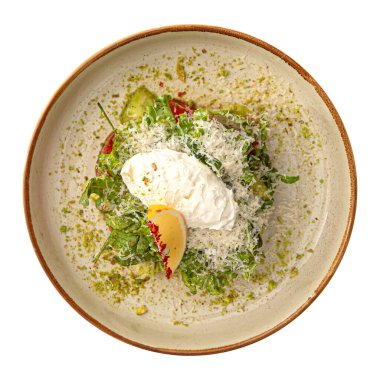 Isolated portion of gourmet avocado salad with tomato and greens