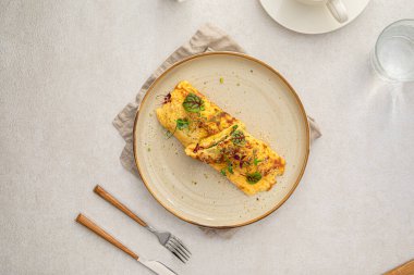 Portion of gourmet omelette with avocado and salmon