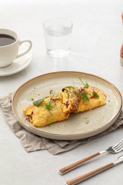 Portion of gourmet omelette with avocado and salmon