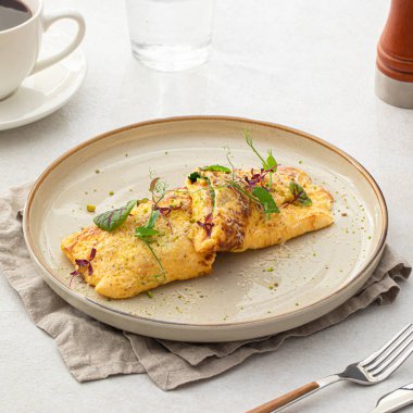 Portion of gourmet omelette with avocado and salmon