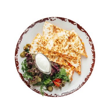 Isolated quesadilla slices with chicken fillet white sauce