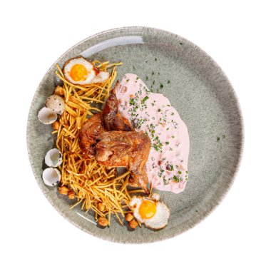 Isolated cooked quail with pai potatoes chickpeas and eggs 