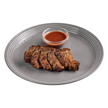 Isolated portion of gourmet roast beef with red sauce