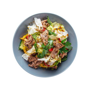 Isolated portion of gourmet salad with roast beef and vegetables