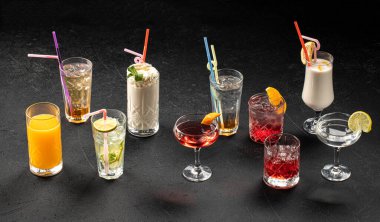 Assorted variety of different cocktails on grey background