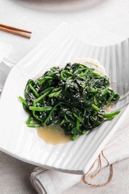 Closeup on portion of asian garlic spinach salad