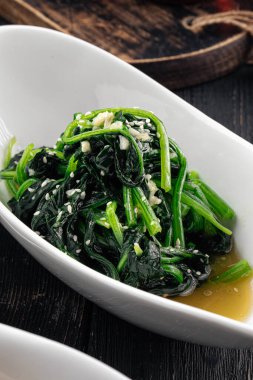 Closeup on portion of asian garlic spinach salad