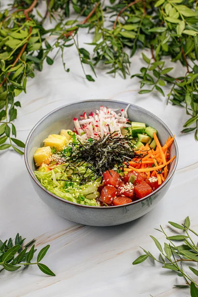 Portion of gourmet tuna poke bowl with vegetables