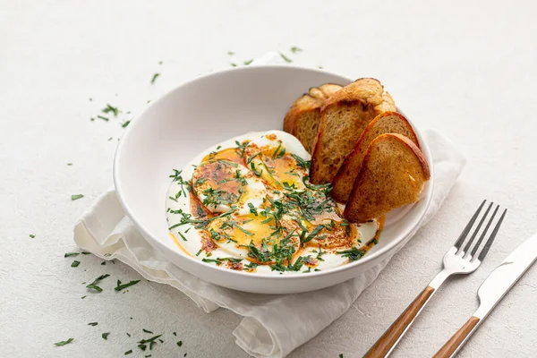 stock image Portion of gourmet eggs breakfast with sauce and bread