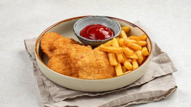 Patates kızartması ve ketçaplı kızarmış tavuk şnitzeli.