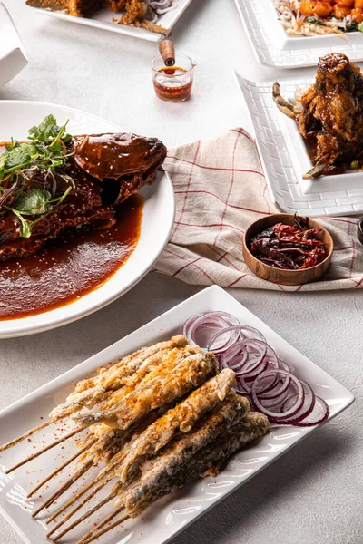 stock image Closeup on asian chinese dishes with capelin fish