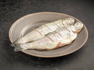 Gri arkaplanda iki çiğ balık