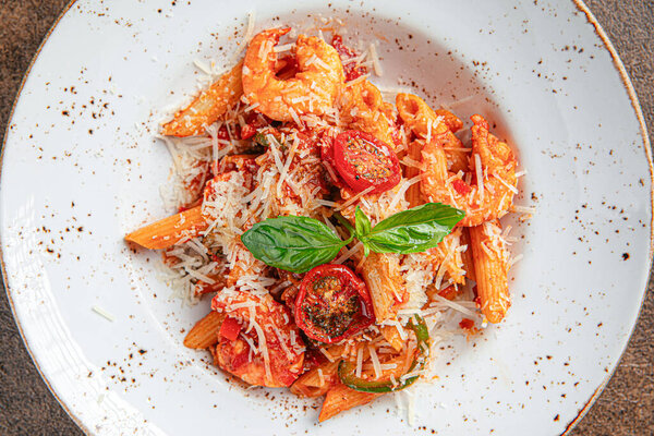 Portion of shrimp penne pasta with mexican sauce