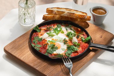 Yumurtalı ve kahveli gurme shakshuka kahvaltısı.