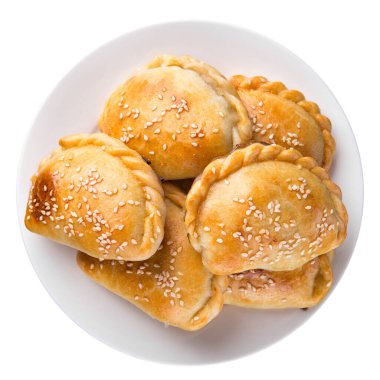 Geleneksel hamur işlerinde altın kabuklu ve susamlı hamur işleri, beyaz bir tabakta sıralanmıştır.