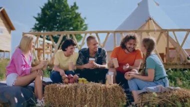 In the perfect place in nature at campsite group of girls and guys enjoy the time together at the campsite they have a conversation all together. Shot on ARRI