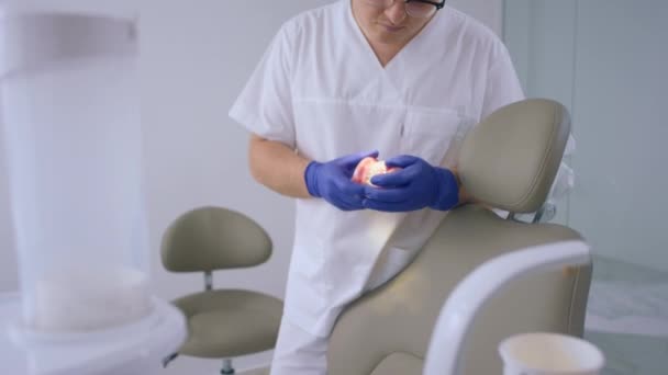 Large Modern Dental Clinic Handsome Dentist Man Holding Model Teeth — Stock video