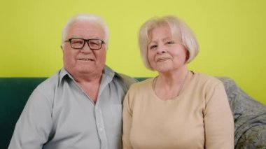 Happy and excited couple old looking in front of the camera posing together they smiling large and looking straight to the camera.