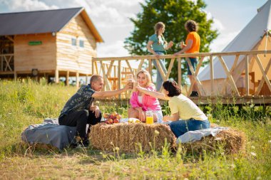Group of best friends meeting all together at the campsite together they have fun time discussing and enjoy the time together in the middle of nature. Portrait