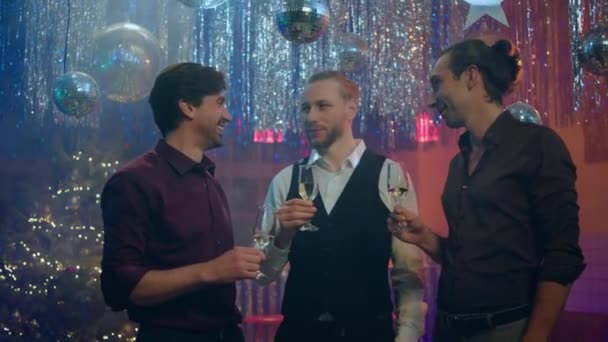 新年の素晴らしいディスコクラブやクリスマスパーティーで かわいいハンサムな男たちが議論し 一緒にシャンパングラスを開催して夜を楽しむことを祝います — ストック動画