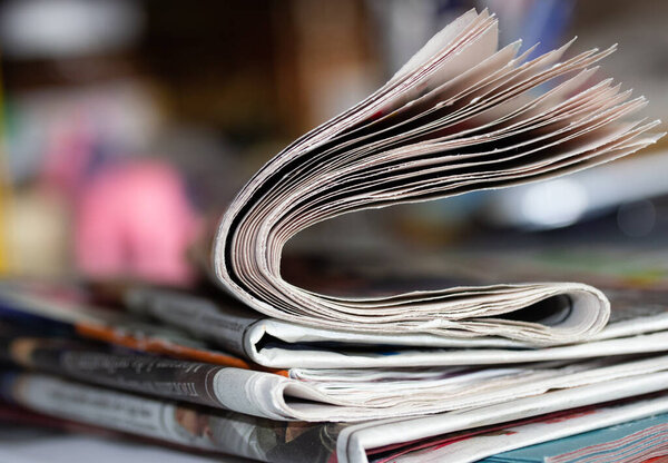 pile of magazines on a desk