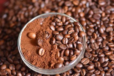 roasted coffee beans in a glass on a white background