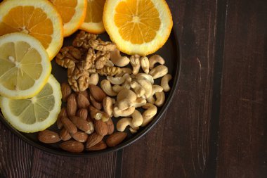 healthy breakfast. lemon, oranges and nuts