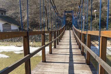 wooden pier with a bridge over the river in the forest