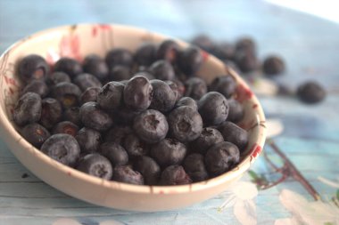 Tahta kasede taze böğürtlen, seçici bir odak.