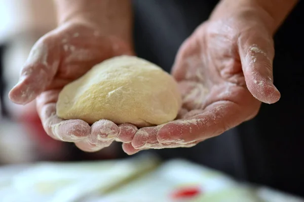白い背景にパンを作るための生地を持つ女性の手 — ストック写真