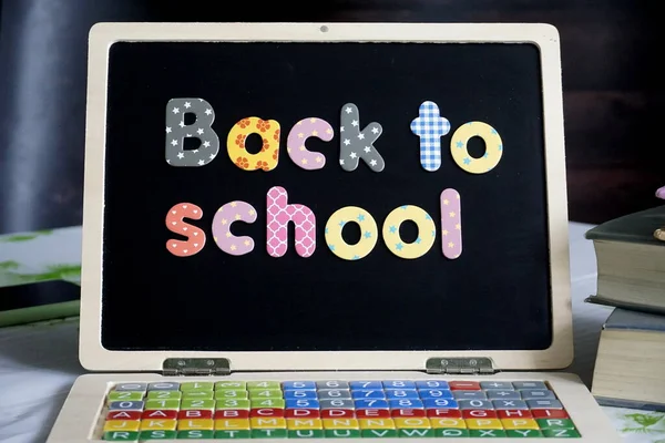 word writing text back to school. business concept for the new education of the new year or college student written on the blackboard on the background