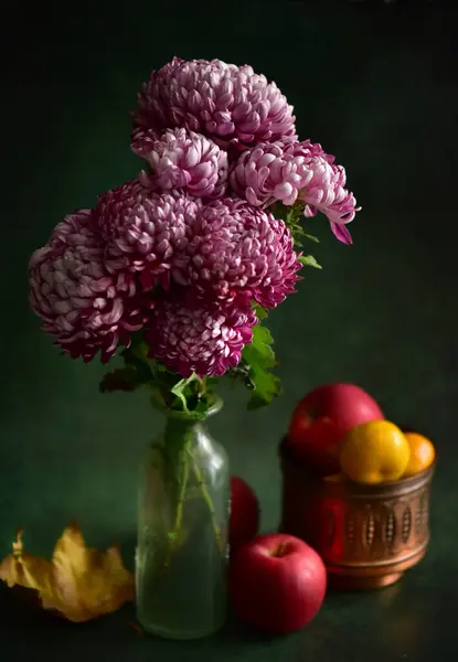 Still life with a bouquet of peonies on a black background