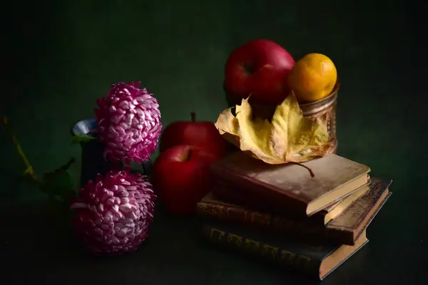Vintage still life with books, apples and flowers