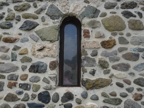 Stone wall with window on a church