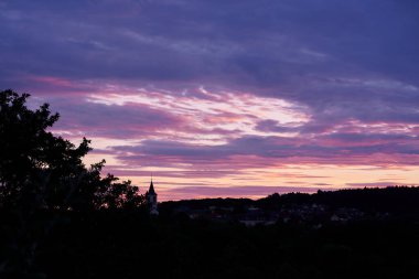 Gün batımına karşı köy ve ormanın silueti