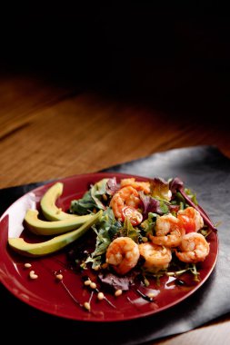 Avokadolu salata ve ahşap bir masada karides. Sağlıklı yemek..