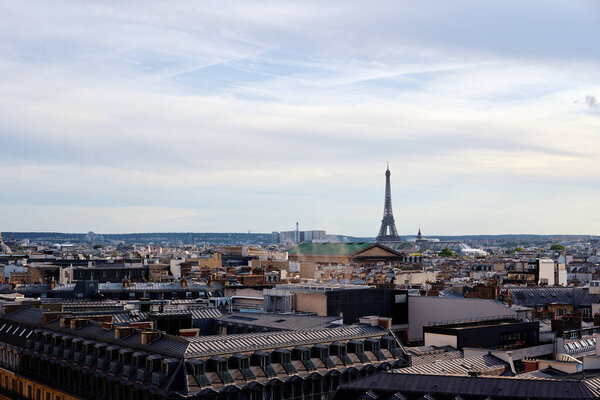 Paris cityscape. Rooftops of the buildings, Eiffel Tower in the background