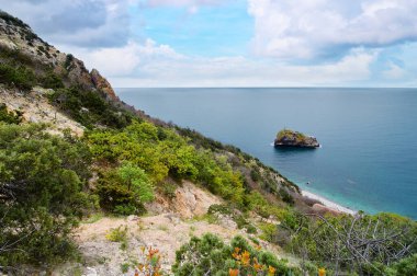 Kıyı şeridi manzarasında kayalar ve dalgalar.