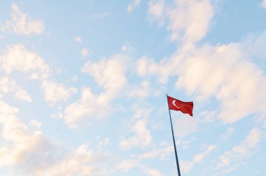National Turkish flag waving against blue sky. clipart