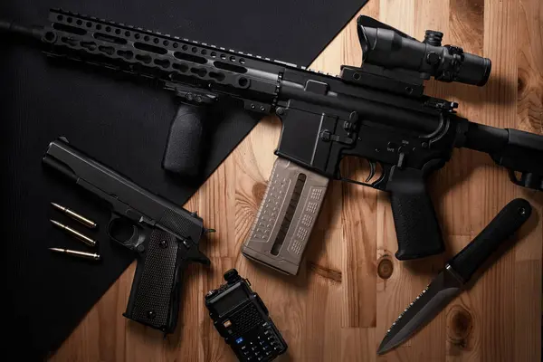 Stock image Weapons and military equipment for army, Assault rifle gun and pistol on wooden background.