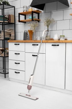 Mop for cleaning floor with special liquid and microfiber cloth inside flat.