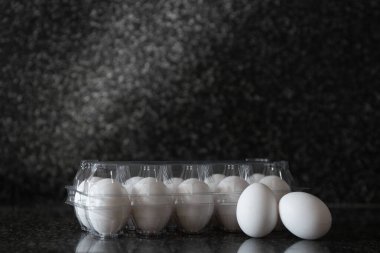 Eggs in plastic packaging on a Kitchen table. Concept of food preparation. Copyspace for text.