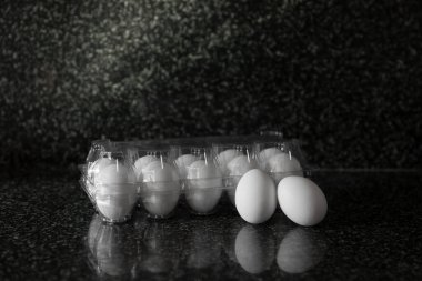 Eggs in plastic packaging on a Kitchen table. Concept of food preparation. Copyspace for text.