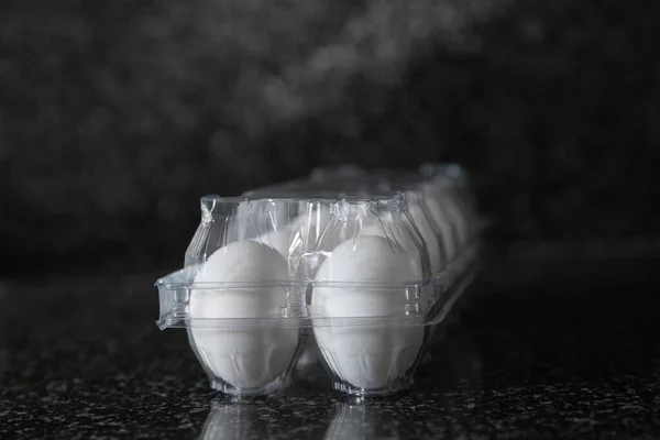 Eggs in plastic packaging on a Kitchen table. Concept of food preparation