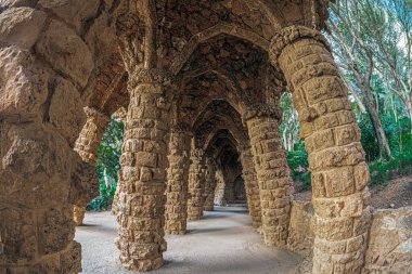 Barcelona, Catalonia, Spain - Feb. 28,2022: Colonnaded in Vaulted Passage in Park Guell on Carmel Hill, architect Antoni Gaudi. Built 1900-1914, officially opened in 1926. UNESCO World Heritage Site.