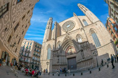 BARCELONA, SPAIN - FEBRUARY 27, 2022: Square Santa Maria with Basilica Santa Maria del Mar, a 14th-century Gothic-style church with three naves and tall columns, plus grand stained glass windows.
