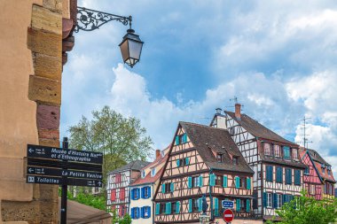 COLMAR, ALSACE, FRANCE - MAY 5, 2023: Street signs marking the direction to the famous sites to visit in the old town, historic district, of this medieval city. clipart