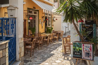 Skiatos Kasabası, Skiatos Adası, GREECE - 20 AĞUSTOS 2023: Eski şehrin Yunan Akdeniz mimarisinde geleneksel tavernalarla dolu dar sokakları görmek.