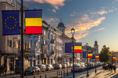 CLUJ NAPOCA, ROMANIA - 6 Ekim 2023: Avram lancu Meydanı kavşağından Kahramanlar Bulvarı boyunca akşam manzarası. Romanya ve Avrupa Topluluğunun bayrakları.